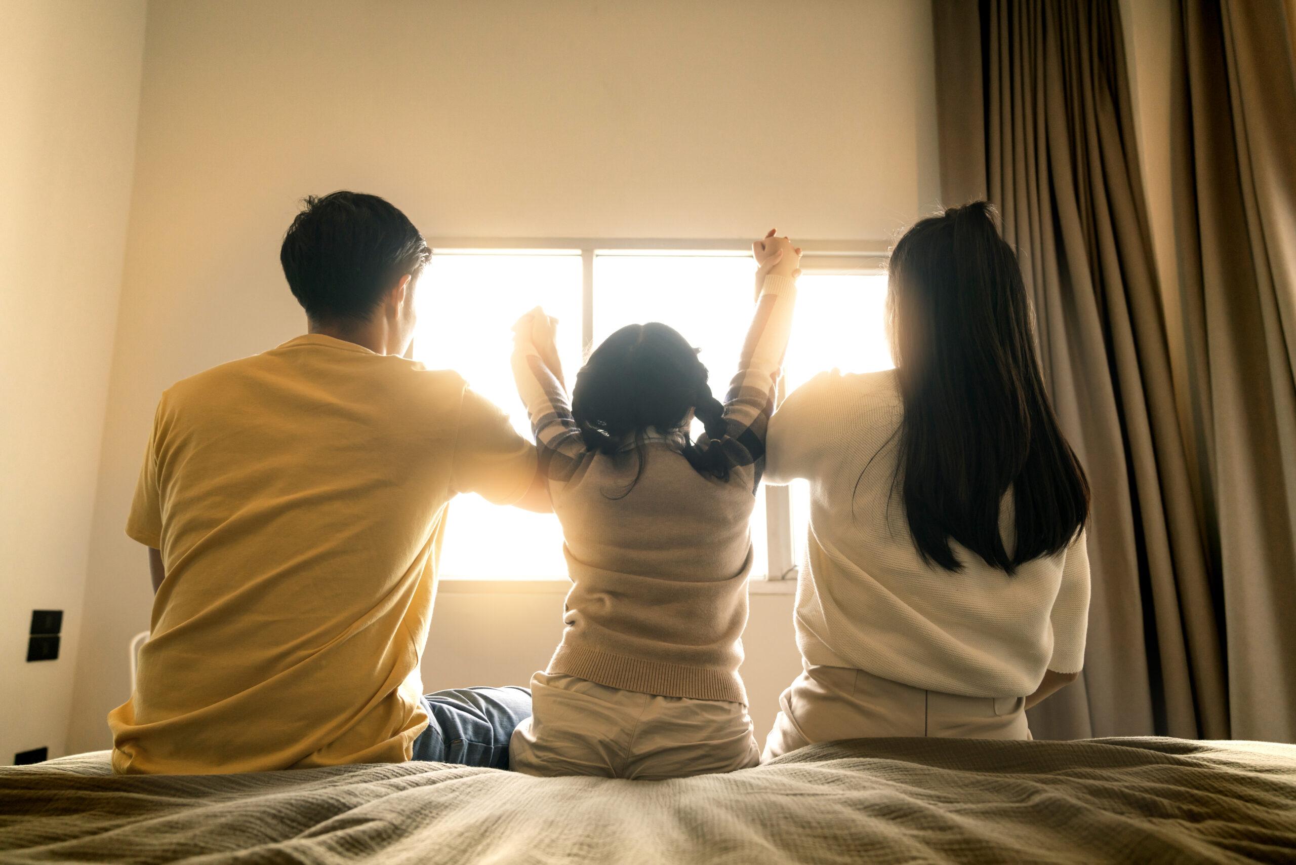 Family with young child happy in a fresh home after post-renovation cleaning services.