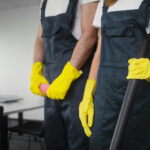 Professional cleaners ready to perform end of tenancy cleaning with professional cleaning equipment.